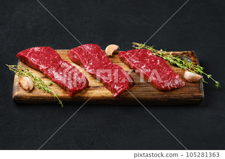 Raw strip steak boneless on cutting board 105281363