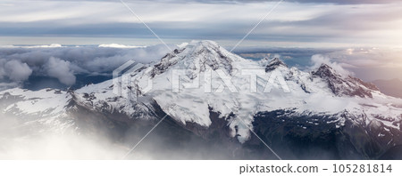 Mt Baker covered in snow and clouds. Aerial landscape nature background. Mt Baker covered in snow and clouds. Aerial landscape nature background. 105281814