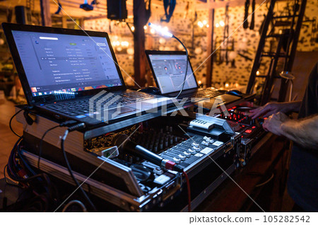 Professional DJ Equipment sound and audio mixer control panel with buttons and sliders Professional DJ Equipment sound and audio mixer control panel with buttons and sliders 105282542