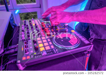 Professional DJ Equipment sound and audio mixer control panel with buttons and sliders 105282572
