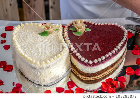 Romantic wedding Two cakes in heart shape, roses bouquet on white table background. Top view Romantic wedding Two cakes in heart shape, roses bouquet on white table background. Top view 105283872