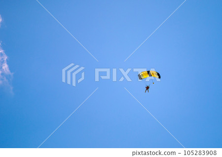 Parachute in the sky. Skydiver is flying a parachute in the blue sky 105283908
