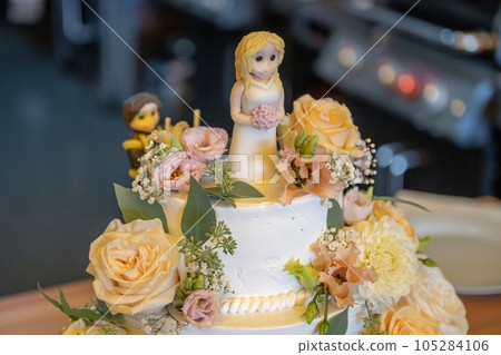 beautiful delicious Wedding cake in many tiers with fresh wild flowers and roses 105284106