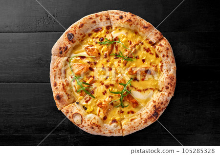 Pizza with melted cheese, sous vide chicken, corn and arugula 105285328