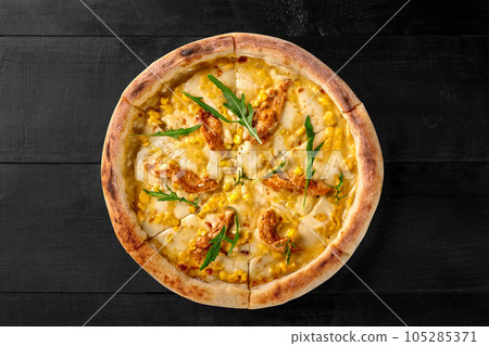 Pizza with cheese, corn, sous vide chicken filet and arugula 105285371