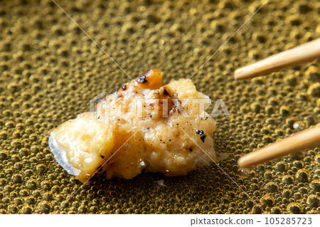 The remaining yakitori (bonjiri) remake cooking scene. Boil in a frying pan with dashi stock to bind the egg. The remaining yakitori (bonjiri) remake cooking scene. Boil in a frying pan with dashi stock to bind the egg. 105285723