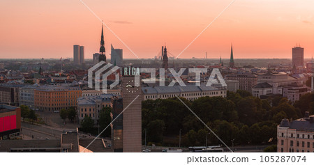 Summer sunset in Riga, Latvia. Aerial view of Riga, the capital of Latvia at sunset. Beautiful buildings, bridges and transport going through the city. 105287074