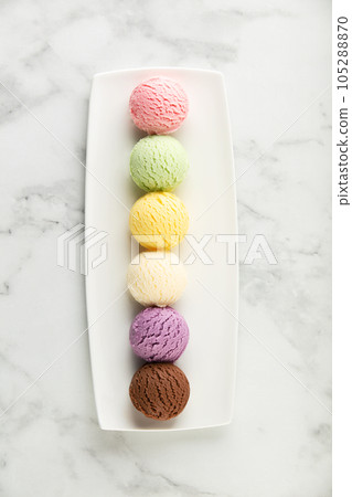 Set of various ice cream scoops on white marble background, top view Set of various ice cream scoops on white marble background, top view 105288870