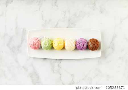 Set of various ice cream scoops on white marble background, top view Set of various ice cream scoops on white marble background, top view 105288871