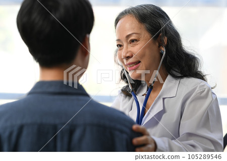 Mature doctor using stethoscope to checking heart and lungs of patient. Medical, consultation, diagnostic and health care 105289546