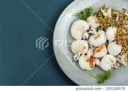 Baked calamari with nuts, space for text. Baked calamari with nuts, space for text. 105289579