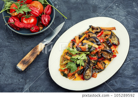Aubergine saute, fragrant vegetable dish. 105289592