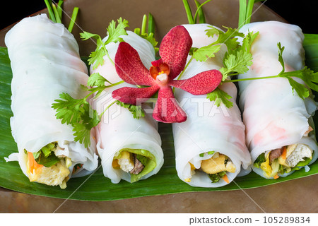 Vietnamese Pho spring roll with seafood, tofu, vegetables isolated on black background for a menu Vietnamese Pho spring roll with seafood, tofu, vegetables isolated on black background for a menu 105289834