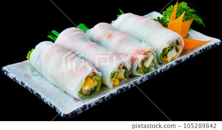 Vietnamese Pho spring roll with seafood, tofu, vegetables isolated on black background for a menu Vietnamese Pho spring roll with seafood, tofu, vegetables isolated on black background for a menu 105289842