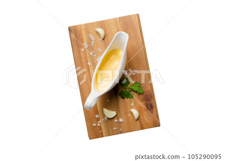 Gravy boat with tasty cheese sauce isolated on white background. top view 105290095