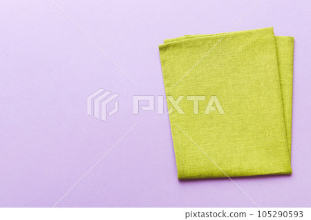 top view with green kitchen napkin isolated on table background. Folded cloth for mockup with copy space, Flat lay. Minimal style top view with green kitchen napkin isolated on table background. Folded cloth for mockup with copy space, Flat lay. Minimal style 105290593