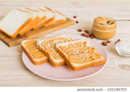 Peanut butter sandwiches or toasts on light table background.Breakfast. Vegetarian food. American cuisine top view vith copy space Peanut butter sandwiches or toasts on light table background.Breakfast. Vegetarian food. American cuisine top view vith copy space 105290707