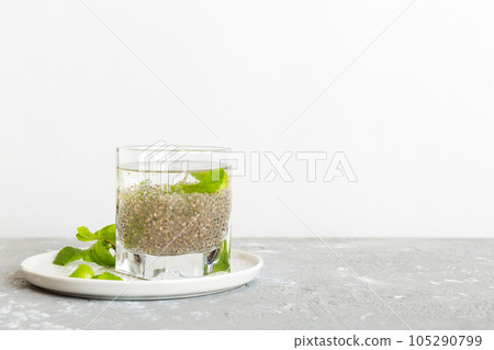 Healthy breakfast or morning with chia seeds and mint on table background, vegetarian food, diet and health concept. Chia pudding with and mint Healthy breakfast or morning with chia seeds and mint on table background, vegetarian food, diet and health concept. Chia pudding with and mint 105290799