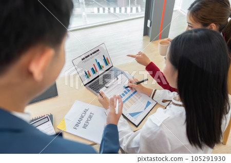 A group of Asian business people meets. have pointed to discussion graphs and data analysis charts and graphs of business finance and management concepts 105291930