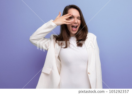 lucky happy brunette woman in dress on studio background with copyspace 105292357