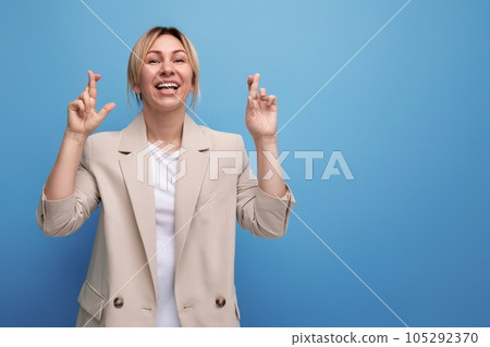 close-up of a positive hopeful blonde business woman in a jacket on the background with copy space close-up of a positive hopeful blonde business woman in a jacket on the background with copy space 105292370