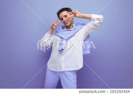 smiling young woman with short haircut in white shirt and blue pants smiling young woman with short haircut in white shirt and blue pants 105292484