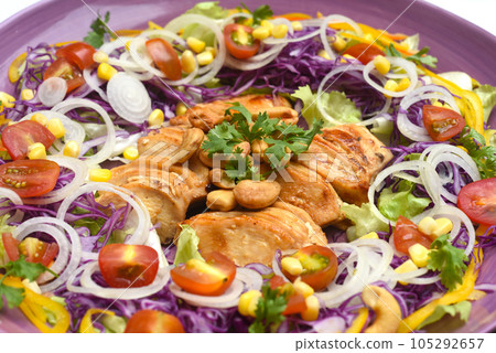 Pan fried chicken on a purple plate with greens and mulberry sauce on wooden table Pan fried chicken on a purple plate with greens and mulberry sauce on wooden table 105292657