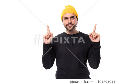 young well-groomed caucasian brunette man with a beard in an informal style shows his hands to the 105293034