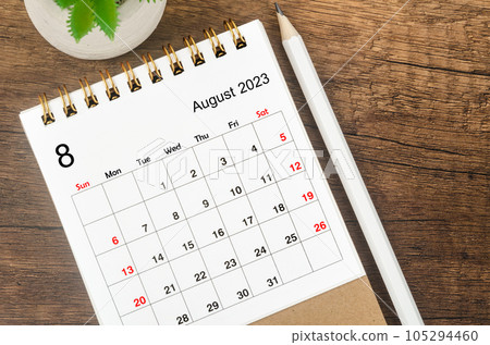 The August 2023 desk calendar for 2023 with pencil on wooden background. The August 2023 desk calendar for 2023 with pencil on wooden background. 105294460