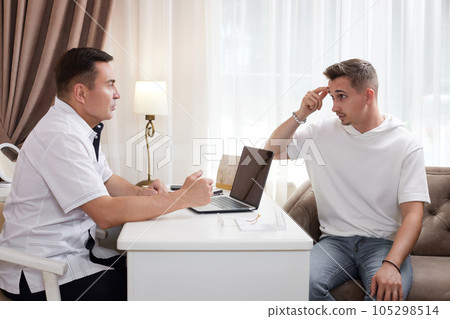 man talking with doctor about face aesthetic treatment 105298514