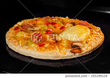 Baked homemade pizza in electric oven at home Baked homemade pizza in electric oven at home 105299126