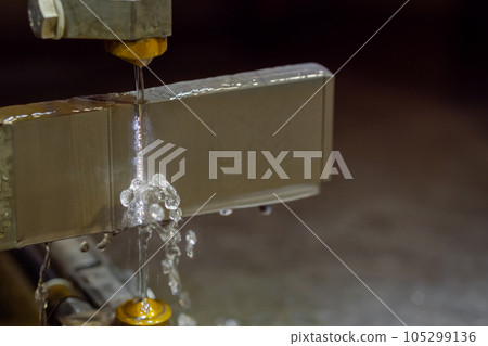 Wire cutting machine working with metal workpiece with sparks at factory Wire cutting machine working with metal workpiece with sparks at factory 105299136