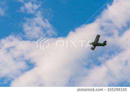 Biplane flying in blue sky at Air Show Biplane flying in blue sky at Air Show 105299185