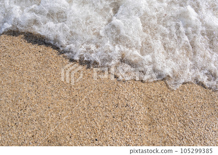 A soft wave runs on a sandy shore on a summer day. Empty space can be used as background for display or montage your top view products. 105299385