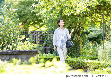 young woman walking in green 105299415