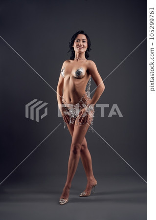 Attractive naked woman with glitter covering nipples Attractive naked woman with glitter covering nipples 105299761