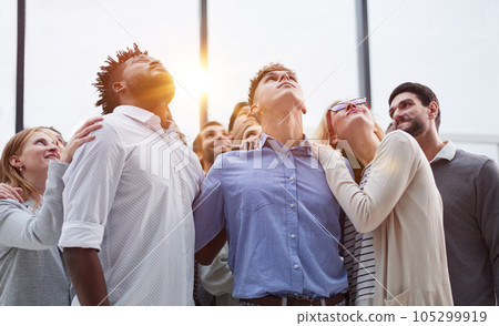 Group of young business people looking up Group of young business people looking up 105299919
