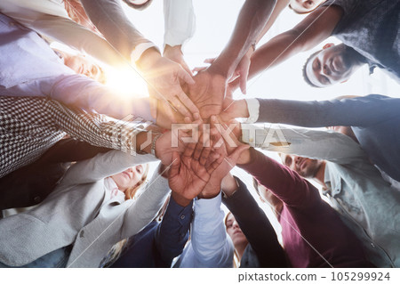 Many hands together, group of joining hands 105299924
