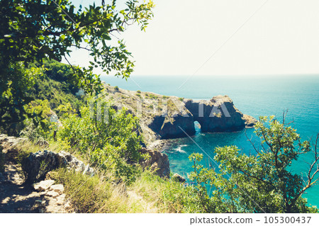 Amazing view on sea and mountains in the distance in hot summer. Vacation, summer travel. Black sea, seacoast. Crimea. Amazing view on sea and mountains in the distance in hot summer. Vacation, summer travel. Black sea, seacoast. Crimea. 105300437