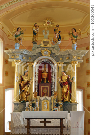 Saint Vitus between St Barbara and St. Lucia, main altar in Chapel of Saint Vitus in Komor Zacretski, Croatia 105300545