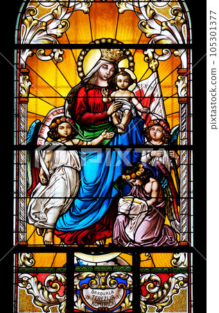 Virgin Mary with baby Jesus and Angels, stained glass window in the Saint John the Baptist church in Zagreb, Croatia 105301377