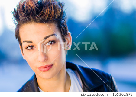 headshot froma a yooung hispanic female. Beautiful woman with an ambiguous hairsyling 105301875