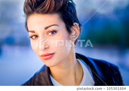 headshot froma a yooung hispanic female. Beautiful woman with an ambiguous hairsyling 105301884