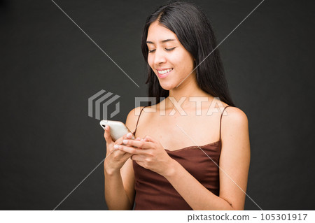 Cellular texting message for social media. Communication technology. Latin American female. Studio 105301917