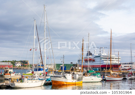 Yachts and boats and cruise liner at pier in port of Svolvaer, Lototen islands, Austvagoya, Vagan Municipality, Nordland County, Norway Yachts and boats and cruise liner at pier in port of Svolvaer, Lototen islands, Austvagoya, Vagan Municipality, Nordland County, Norway 105301964