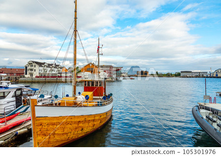 Yachts and boats with lagoon in the background at pier in Svolvaer, Lototen islands, Austvagoya, Vagan Municipality, Nordland County, Norway 105301976