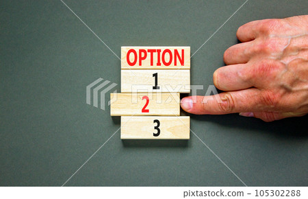 Time to option 2 symbol. Concept word Option 1 2 3 on wooden block. Businessman hand. Beautiful grey table grey background. Business planning and time to option 2 concept. Copy space. 105302288