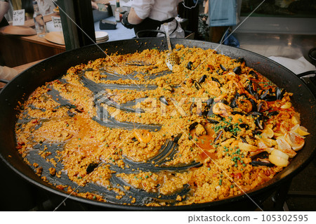 Seafood paella prepared on a street food market Seafood paella prepared on a street food market 105302595