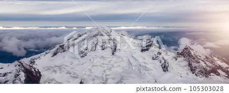 Mt Baker covered in snow and clouds. Aerial landscape nature background. Mt Baker covered in snow and clouds. Aerial landscape nature background. 105303028
