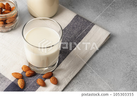 Almond milk with almond nuts in glass Almond milk with almond nuts in glass 105303355